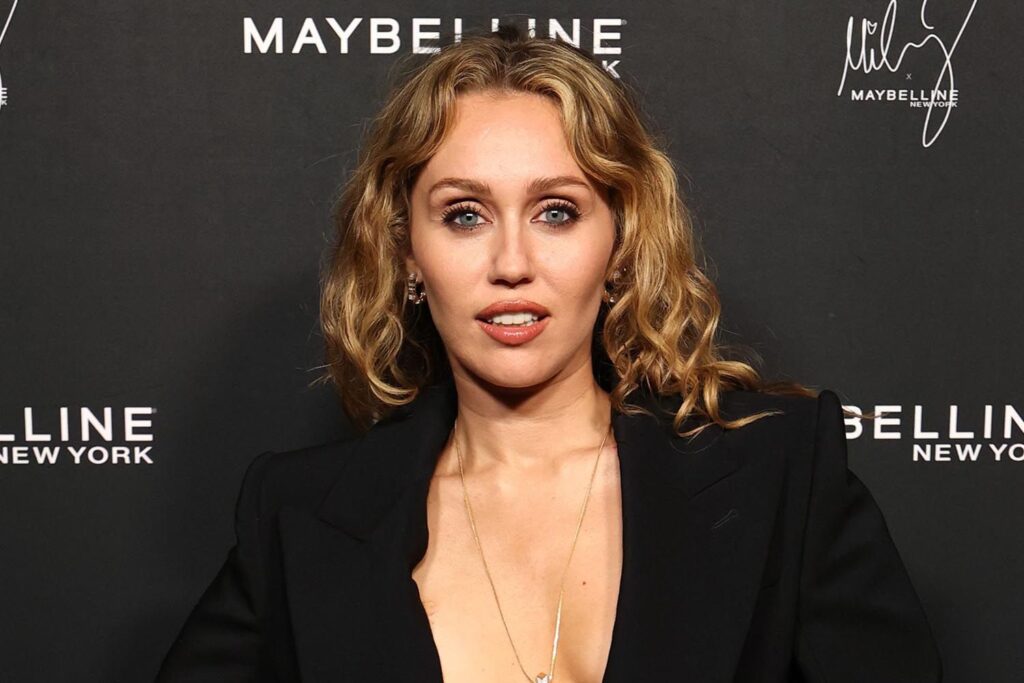 Miley Cyrus Wears Suit Jacket, Nothing Underneath at Maybelline Event